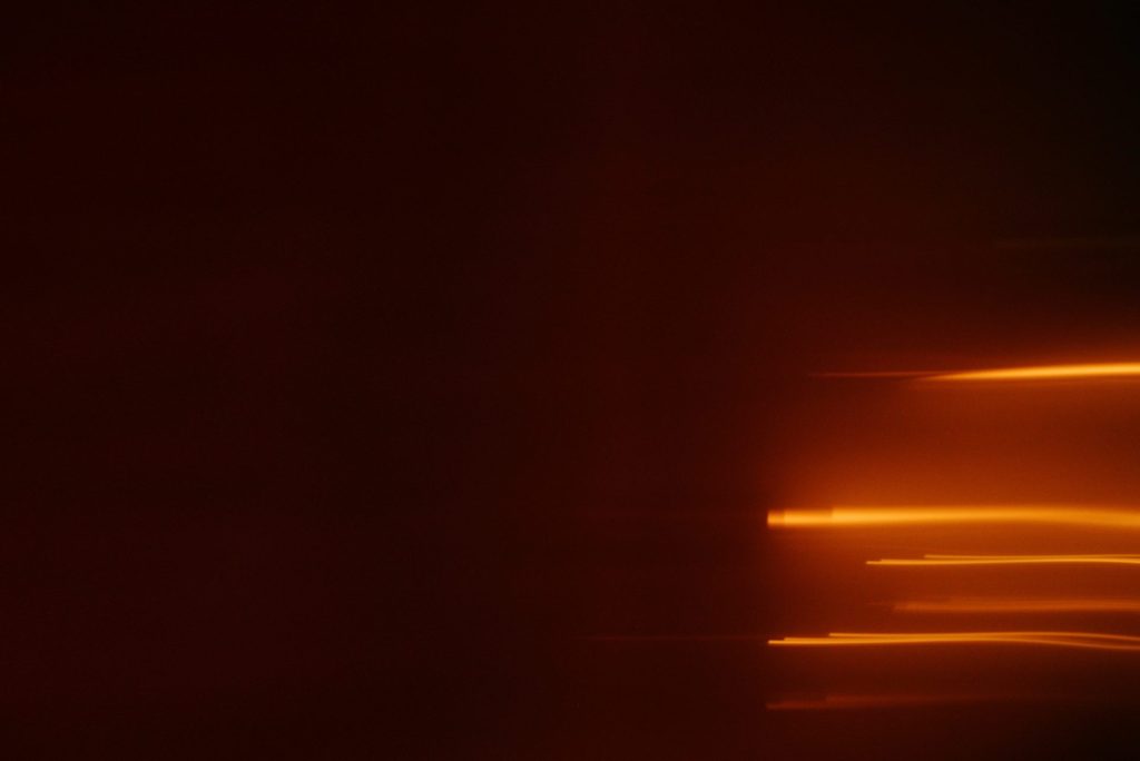 Abstract streaks of orange light on dark background